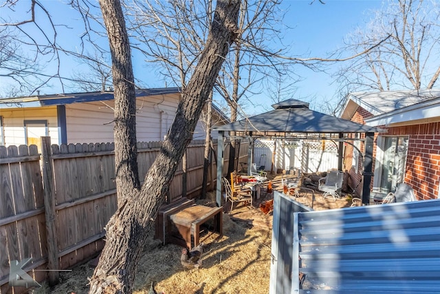 view of yard featuring a fenced backyard and a gazebo