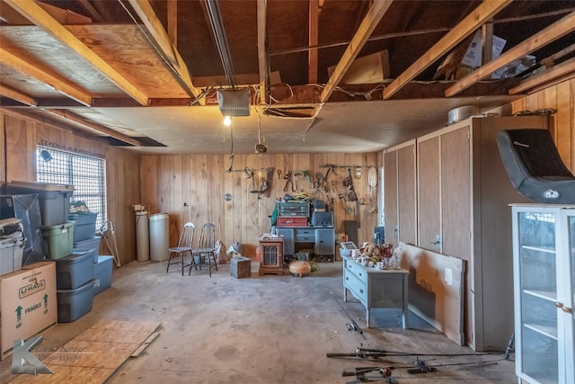 interior space with a garage and wooden walls