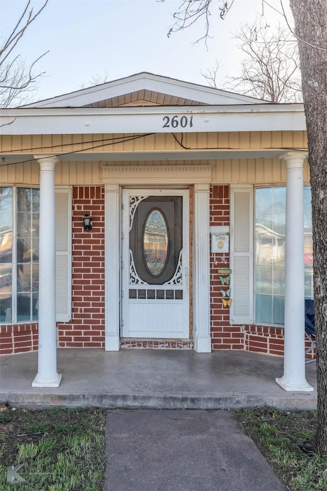 property entrance featuring brick siding