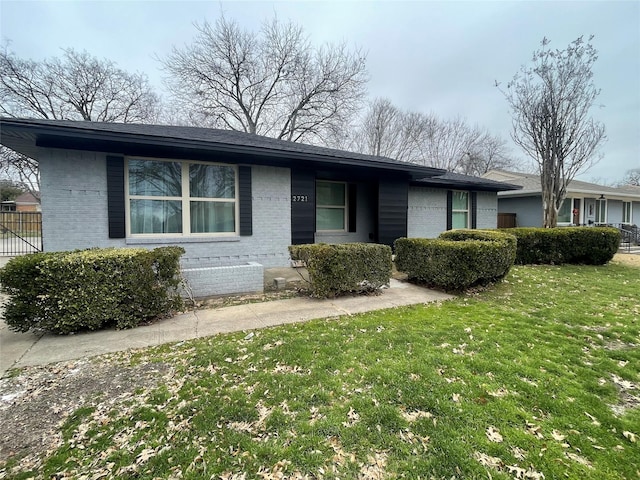 ranch-style home with brick siding and a front lawn