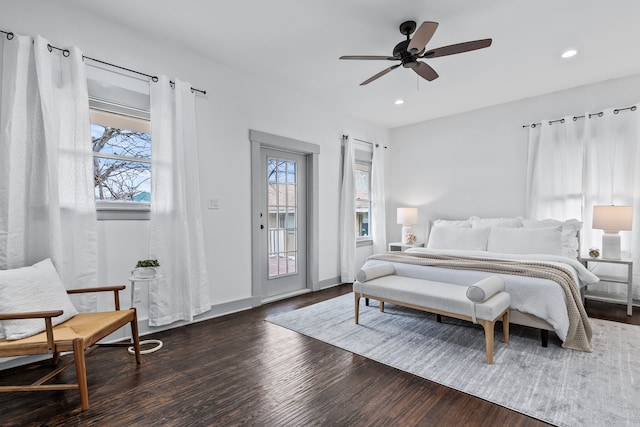 bedroom featuring access to outside, multiple windows, recessed lighting, and wood finished floors