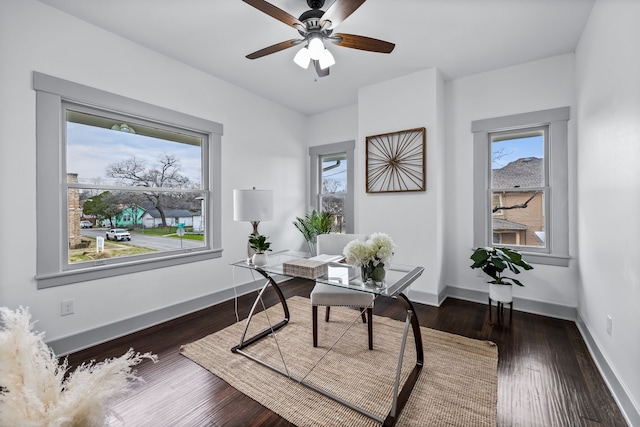 office space featuring dark wood-style floors, ceiling fan, and baseboards