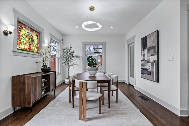 dining room with recessed lighting, visible vents, baseboards, and wood finished floors