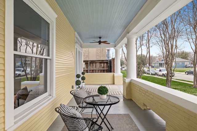 balcony with ceiling fan, a porch, and a residential view