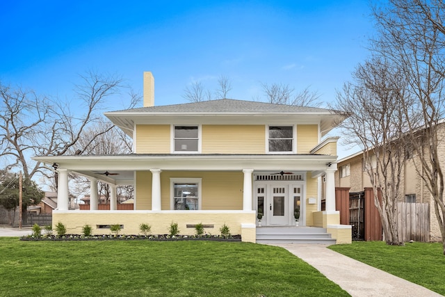 view of front of home featuring french doors, a porch, a front yard, fence, and ceiling fan