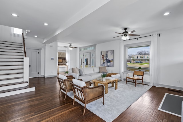 living area featuring baseboards, visible vents, wood finished floors, stairs, and recessed lighting