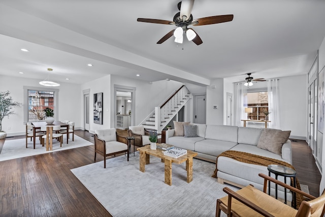 living room with dark wood-type flooring, recessed lighting, baseboards, and stairs