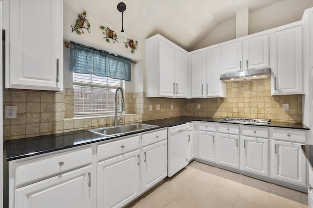 kitchen featuring white dishwasher, under cabinet range hood, a sink, dark countertops, and stainless steel gas stovetop