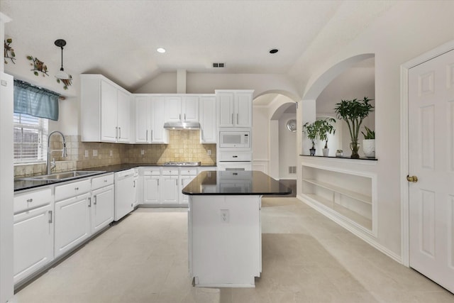 kitchen featuring white appliances, white cabinets, a sink, and under cabinet range hood