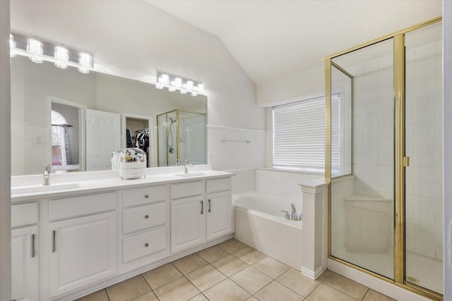 full bathroom with a stall shower, tile patterned flooring, a sink, and lofted ceiling