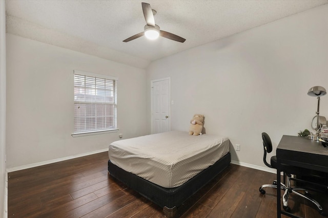 bedroom featuring wood-type flooring, baseboards, vaulted ceiling, and a ceiling fan