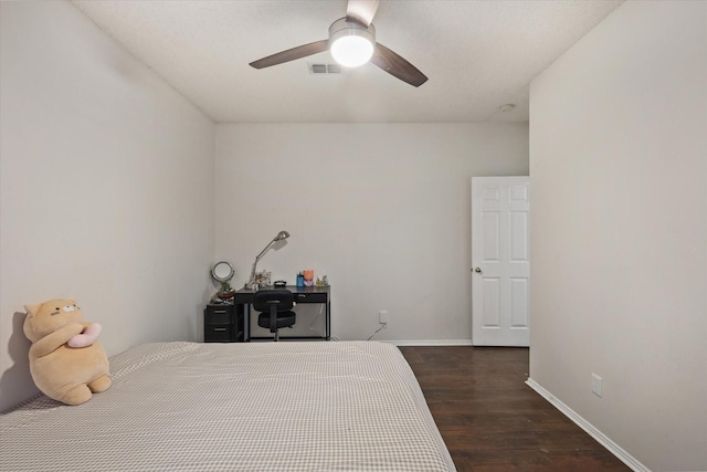 bedroom with a ceiling fan, baseboards, visible vents, and wood finished floors