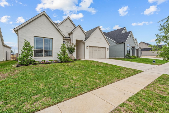 view of front facade with an attached garage, driveway, a front yard, and brick siding