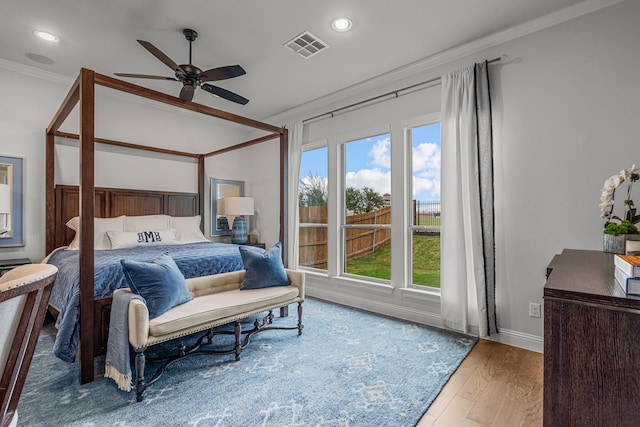 bedroom with recessed lighting, visible vents, crown molding, and wood finished floors