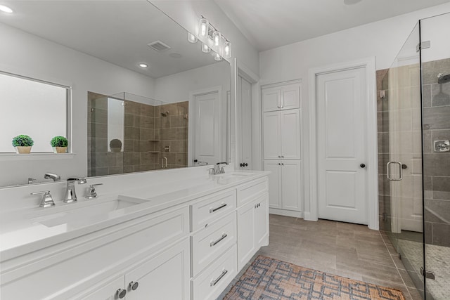 full bath featuring a stall shower, visible vents, and a sink