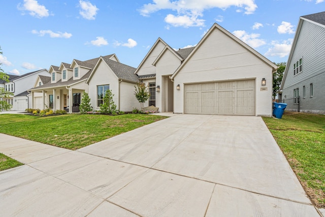 view of front of home featuring a garage, driveway, a residential view, and a front lawn