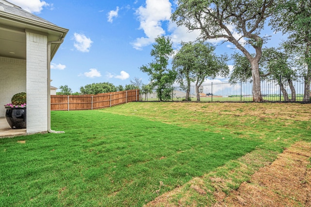 view of yard with a fenced backyard