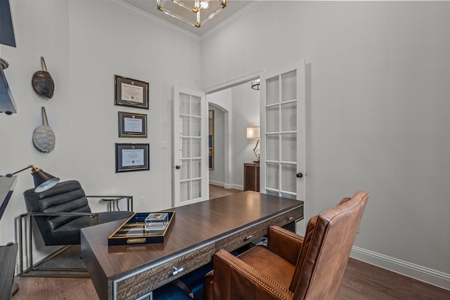 home office with baseboards, arched walkways, wood finished floors, crown molding, and french doors