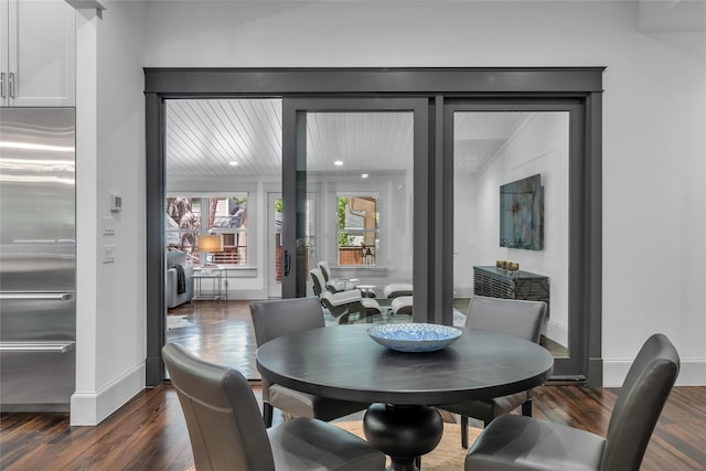 dining room featuring dark wood-style flooring and baseboards