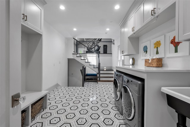 clothes washing area with cabinet space, tile patterned flooring, separate washer and dryer, and recessed lighting