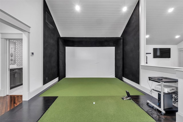 recreation room featuring baseboards, golf simulator, and wood finished floors