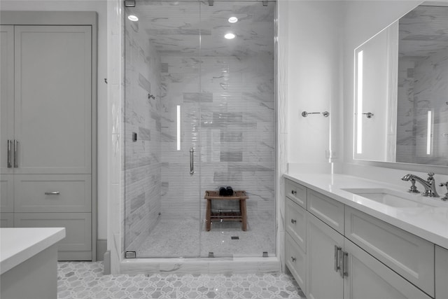 bathroom featuring a stall shower and vanity