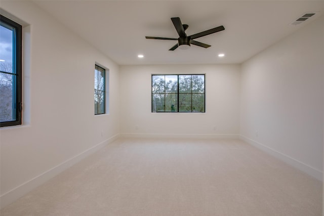 spare room featuring recessed lighting, baseboards, visible vents, and light colored carpet