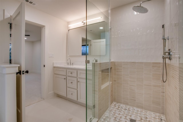 full bath featuring a stall shower, vanity, and visible vents