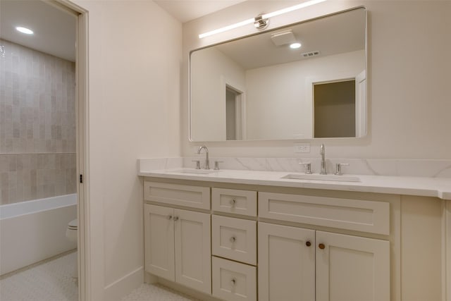 full bathroom featuring visible vents, a sink, toilet, and double vanity