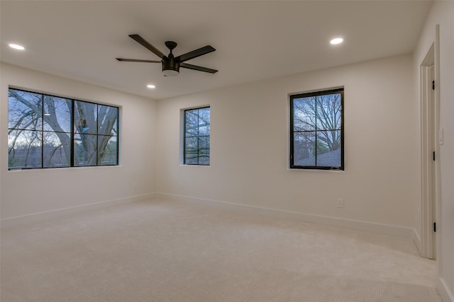 carpeted spare room with a ceiling fan, recessed lighting, and baseboards