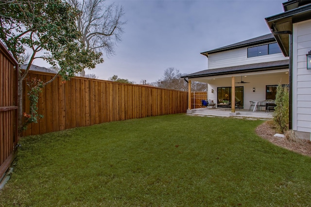 view of yard featuring ceiling fan, a patio area, and a fenced backyard