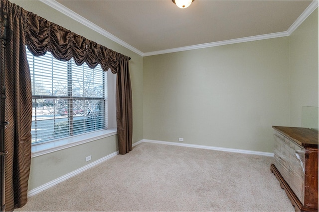 carpeted empty room with baseboards and ornamental molding