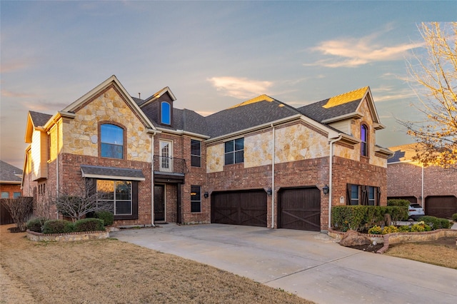 traditional home with brick siding, concrete driveway, and a garage