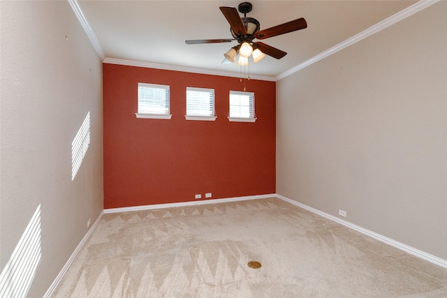 empty room with baseboards, light carpet, a ceiling fan, and crown molding