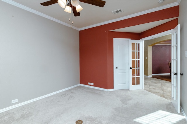 spare room with visible vents, arched walkways, ornamental molding, french doors, and carpet flooring