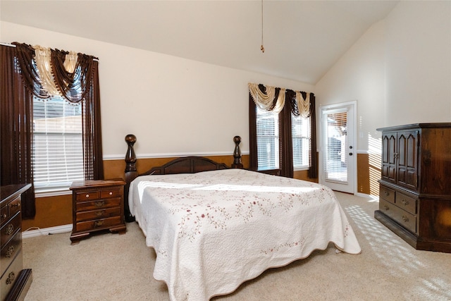 bedroom featuring baseboards, lofted ceiling, light colored carpet, and access to exterior