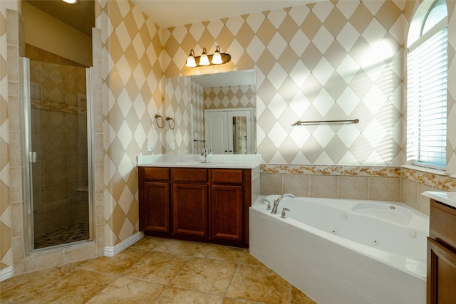 bathroom featuring vanity, a stall shower, and a whirlpool tub