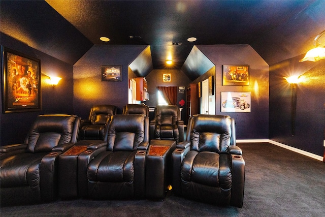 carpeted home theater featuring baseboards and vaulted ceiling