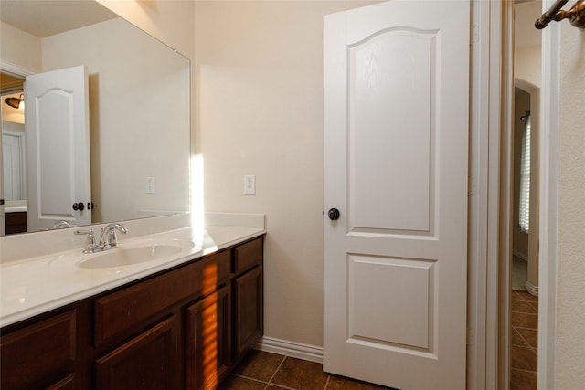 bathroom with tile patterned flooring, vanity, and baseboards