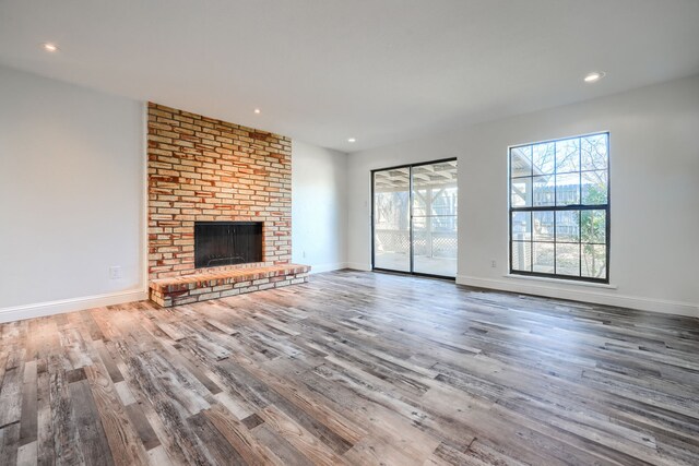 unfurnished bedroom featuring a textured ceiling, wood finished floors, visible vents, and baseboards