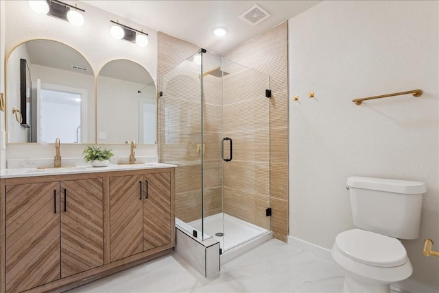 bathroom featuring visible vents, toilet, a sink, a shower stall, and baseboards