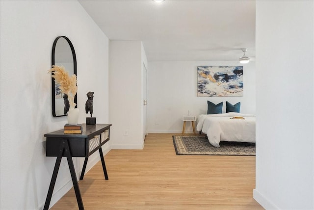 bedroom featuring light wood-style floors and baseboards