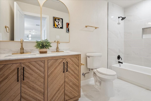 bathroom featuring double vanity, bathing tub / shower combination, a sink, and toilet