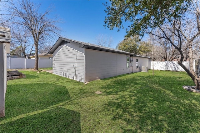 view of property exterior featuring a fenced backyard, central AC unit, and a yard