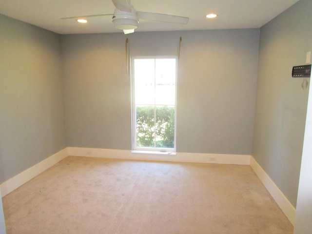 carpeted spare room featuring ceiling fan, baseboards, and recessed lighting