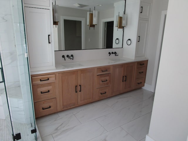 bathroom with marble finish floor, visible vents, a sink, and a shower stall