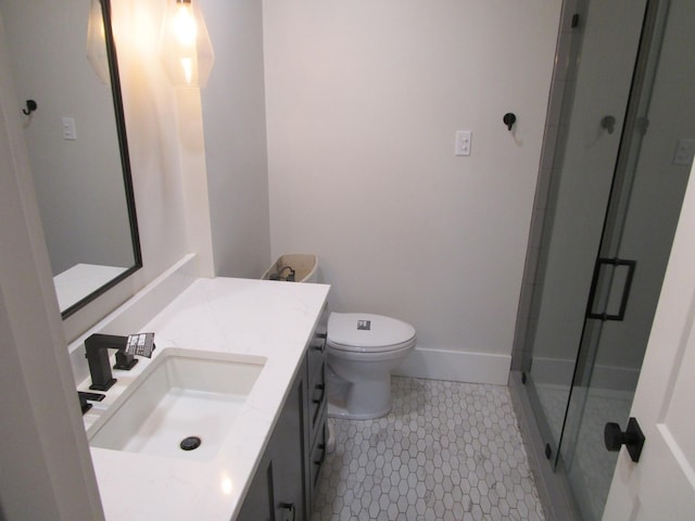 full bathroom with toilet, a shower stall, vanity, tile patterned flooring, and baseboards