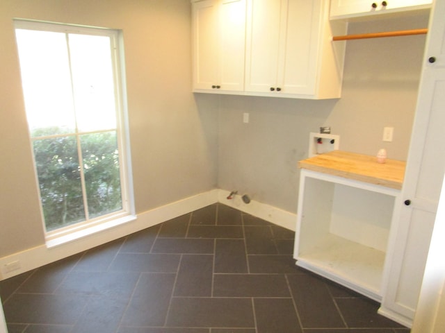 laundry room featuring hookup for a washing machine, baseboards, and a wealth of natural light