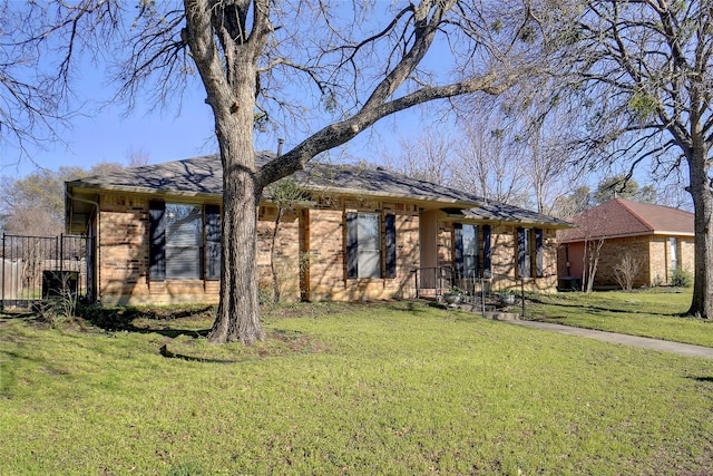 view of front of home featuring a front yard and brick siding