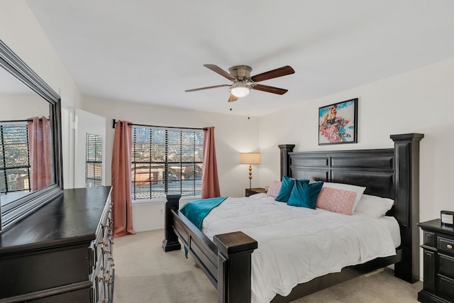 bedroom featuring light colored carpet and a ceiling fan